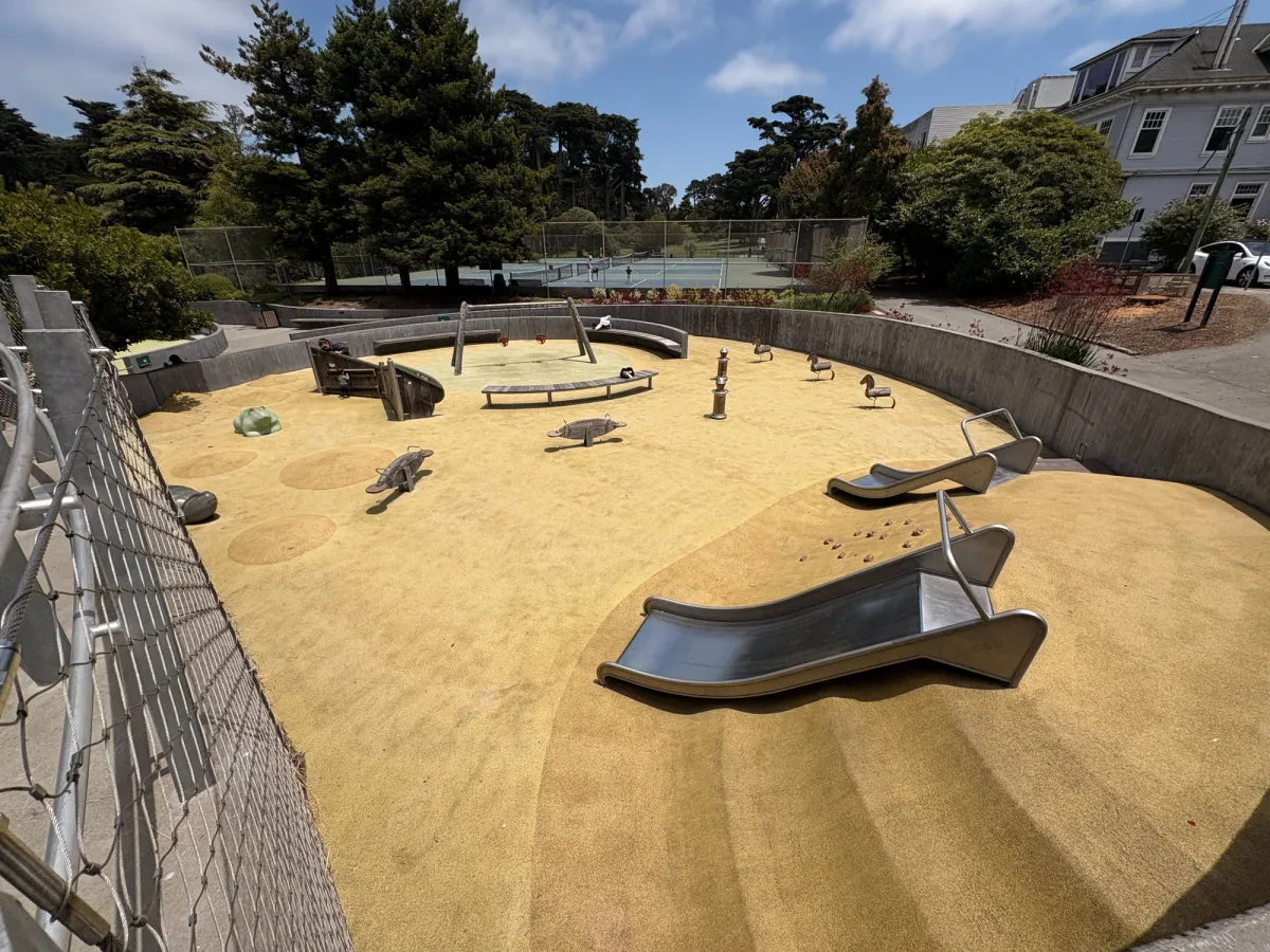 Toddler zone has various slides, ride on toys, and small bucket swings