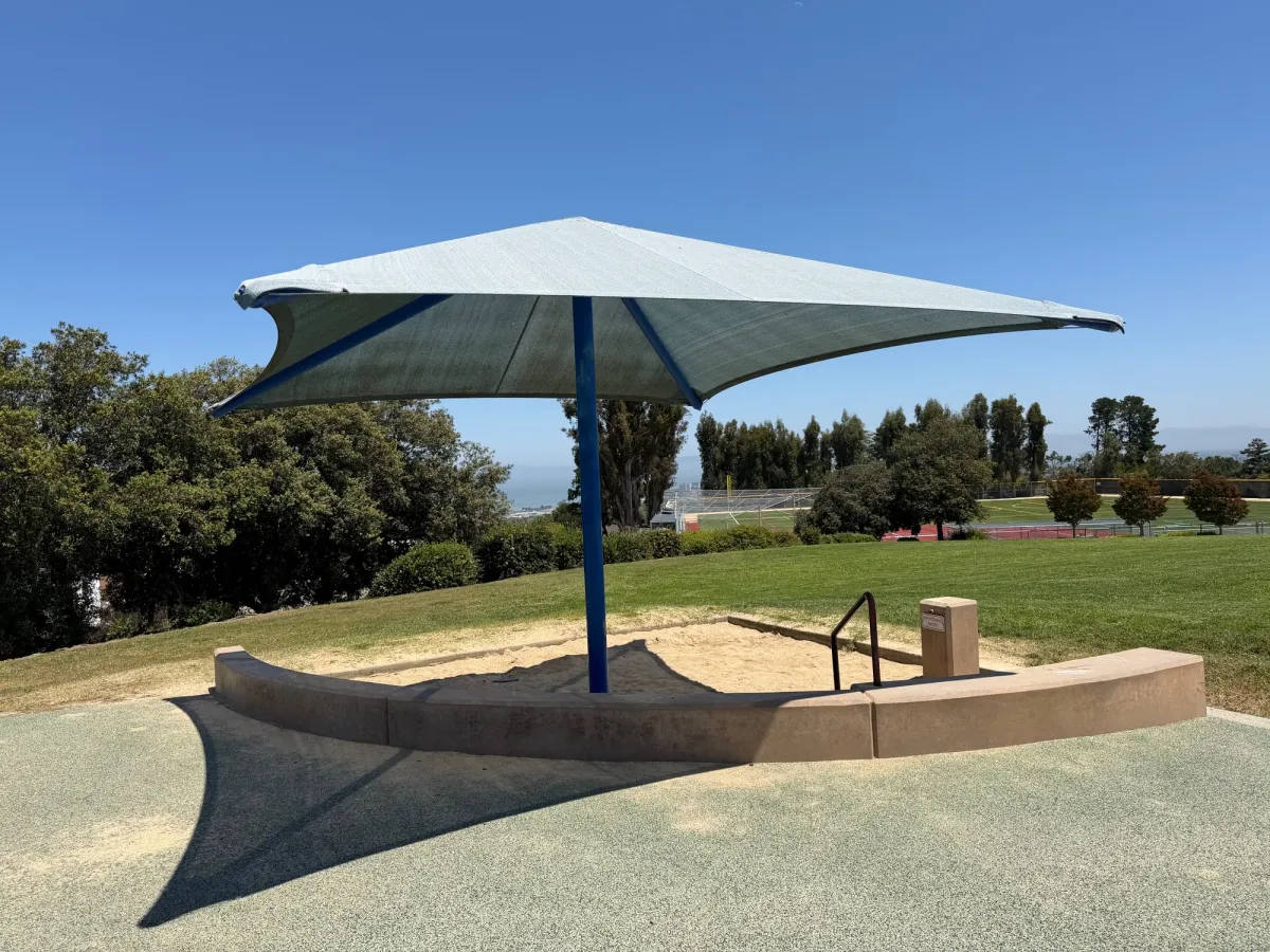 Umbrella throws some shade at the sandbox depending on time of day