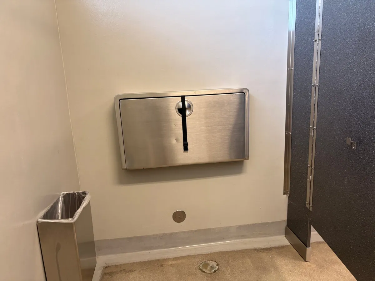Changing tables are in the bathroom stall
