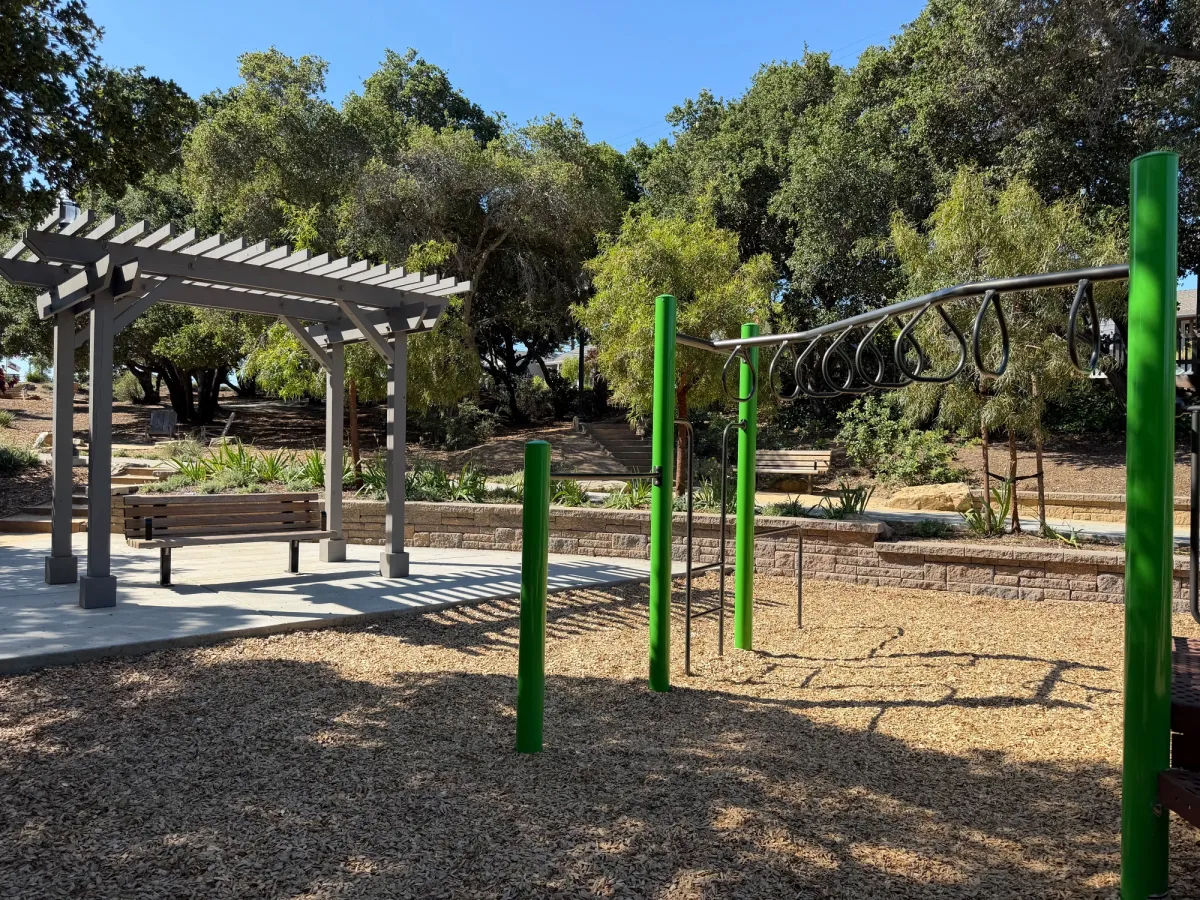 Monkey bars and shaded benches to view children playing