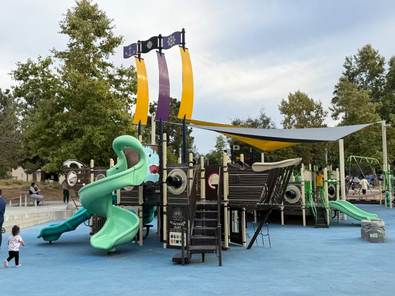 Boat themed bigger kid playground structure with a water monster slide