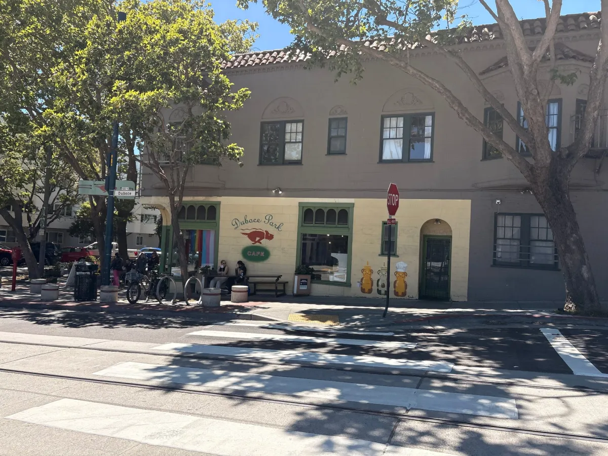 You have to cross the length of the Duboce grass field to get to Duboce cafe but it's a nice walk.