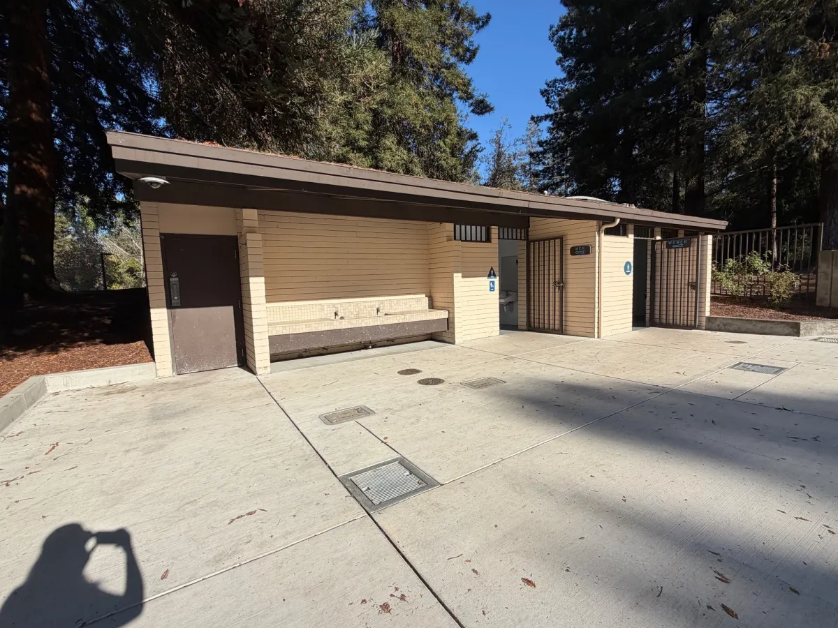 Bathroom facilities, located just outside playground area next to picnic tables