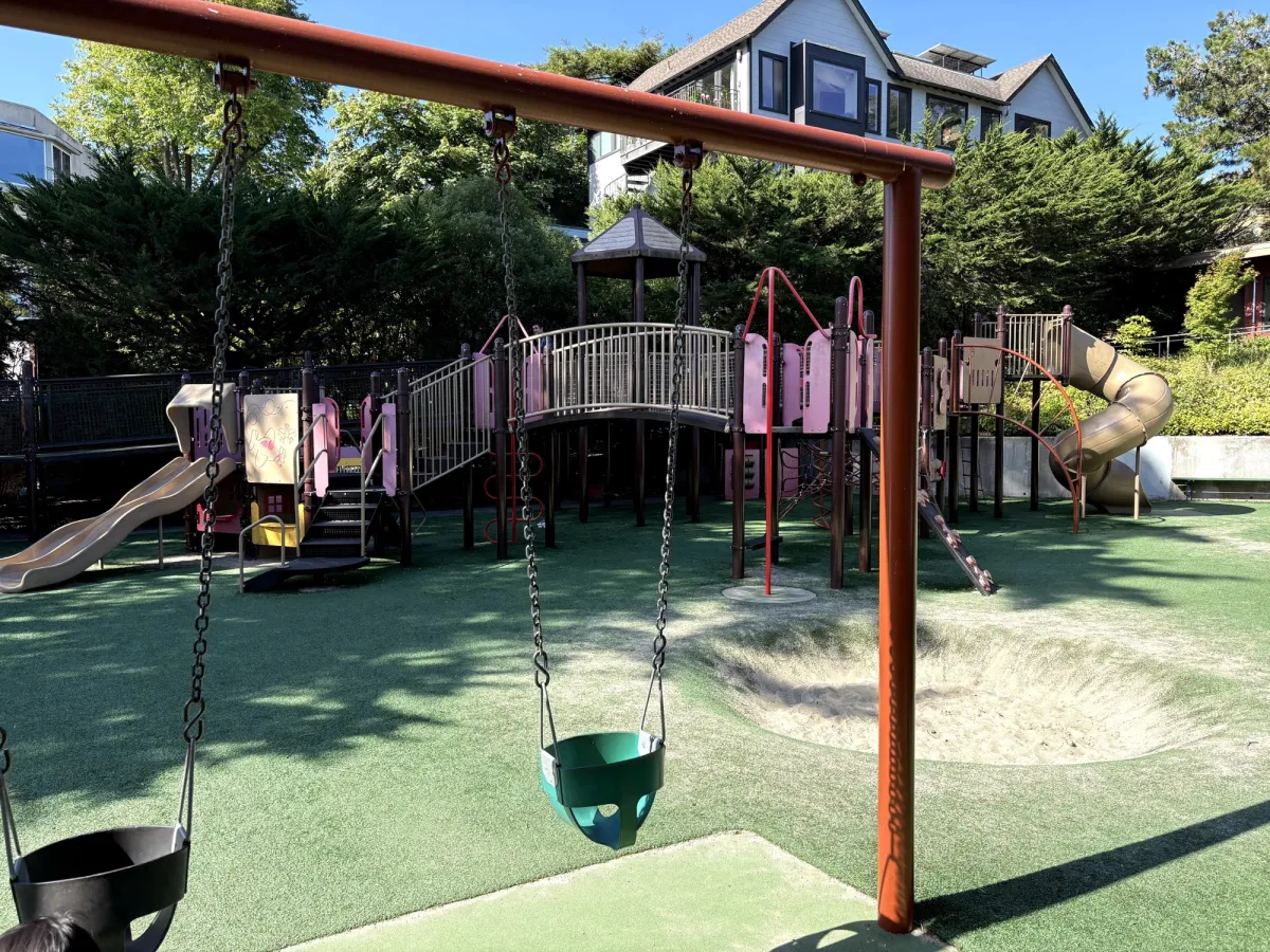 Bucket swings in front of the big kid zone