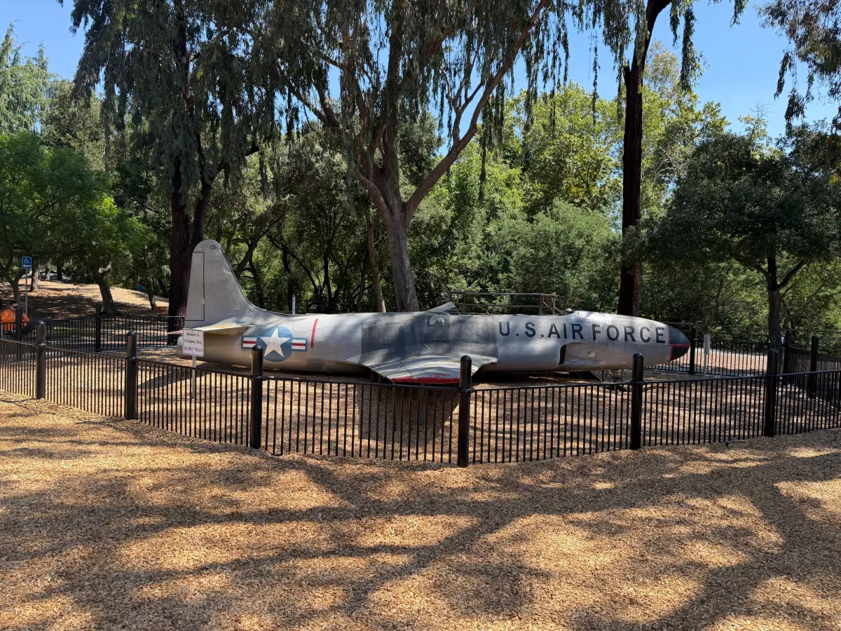A model airplane on display in the playground