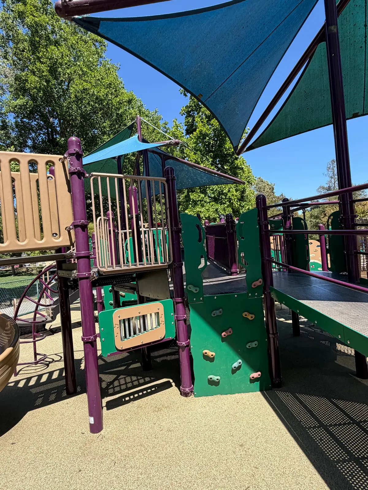 Rock climbing walls and music panels on big kid playground