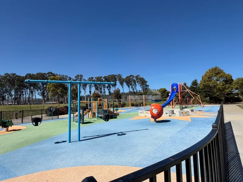 Enclosed playground consists of several stations for play suitable for both younger and older children