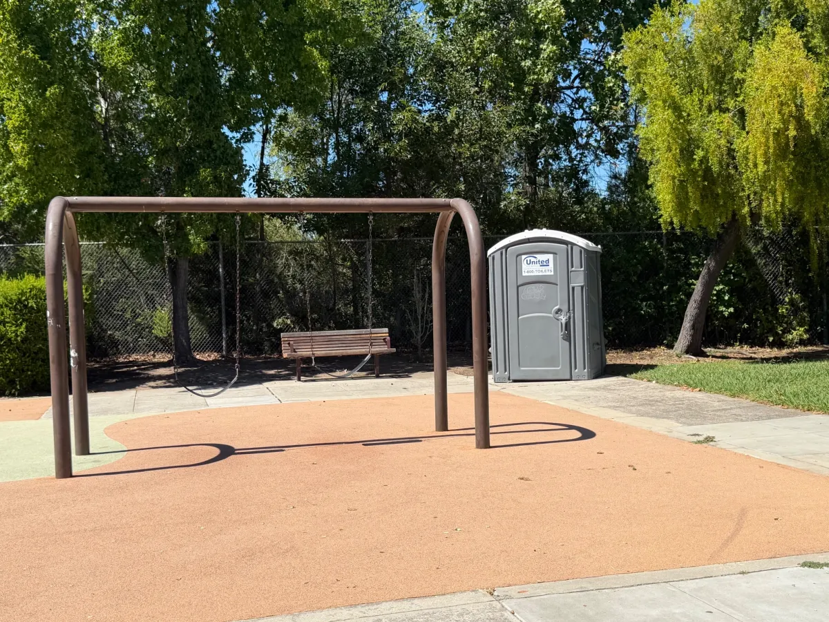 Big kid swings and portable restroom