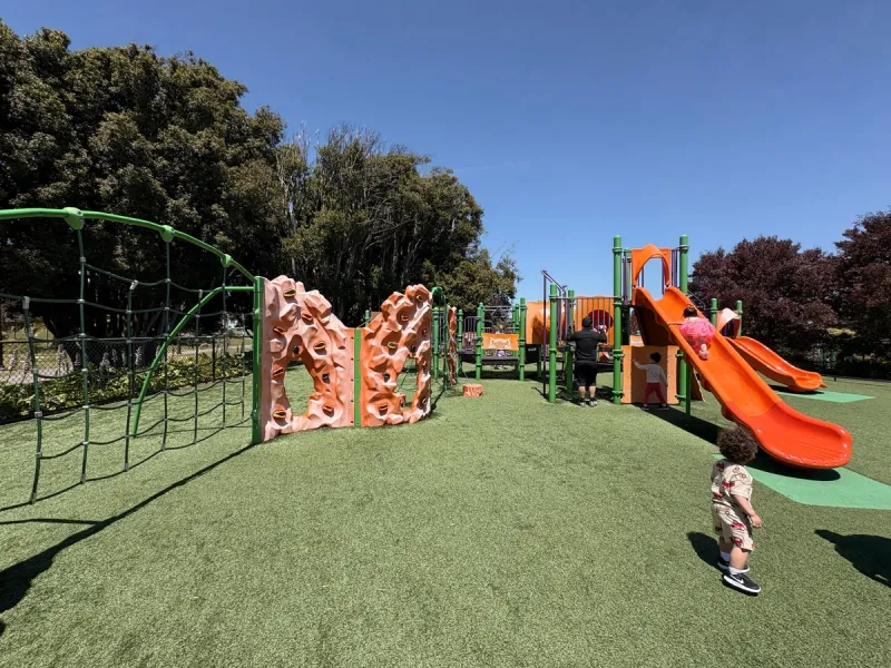 Main playground with an extensive climbing wall, net, and decently tall slides.