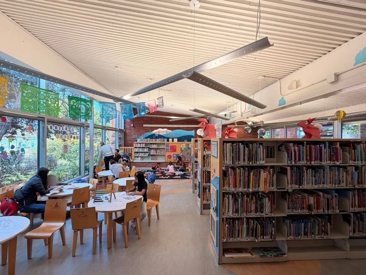 Children's library is well stocked with a small toddler play area