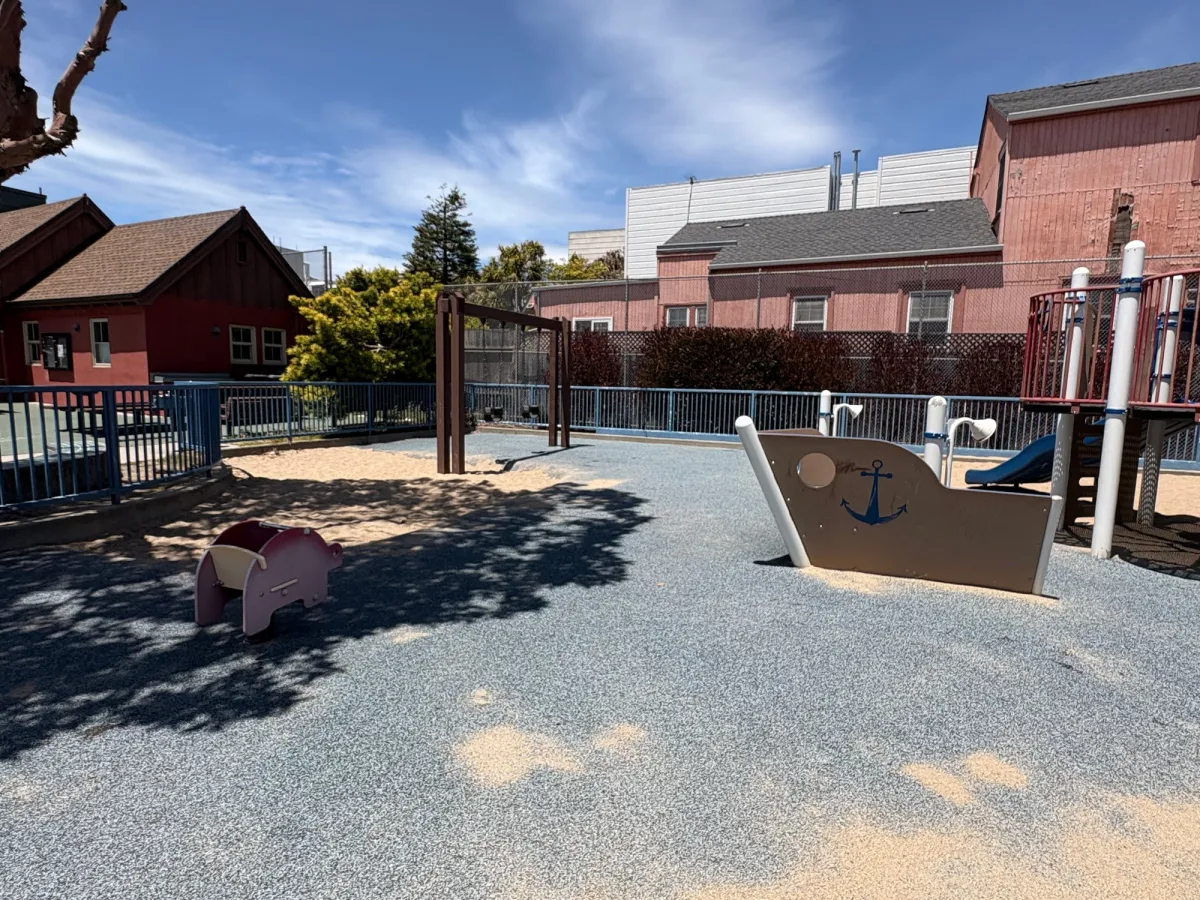 Shaded toddler area with small sand pit