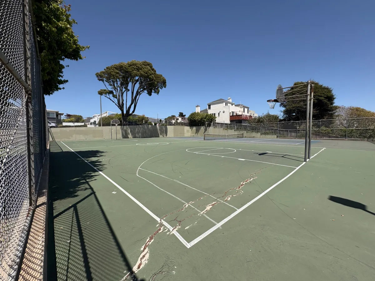 Enclosed basketball and tennis ball court