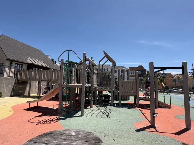 Playground section that includes a bridge for kids to run under