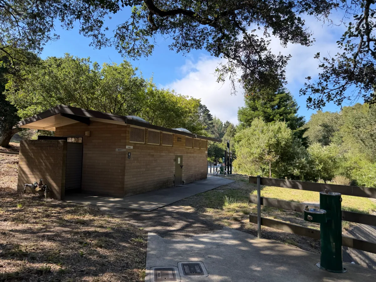 Bathrooms are near playground, just across the small bridge for De Anza