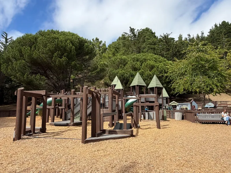 Sprawling frontier themed playground operating like a clubhouse, variety of monkey bars and ramps/bridges throughout