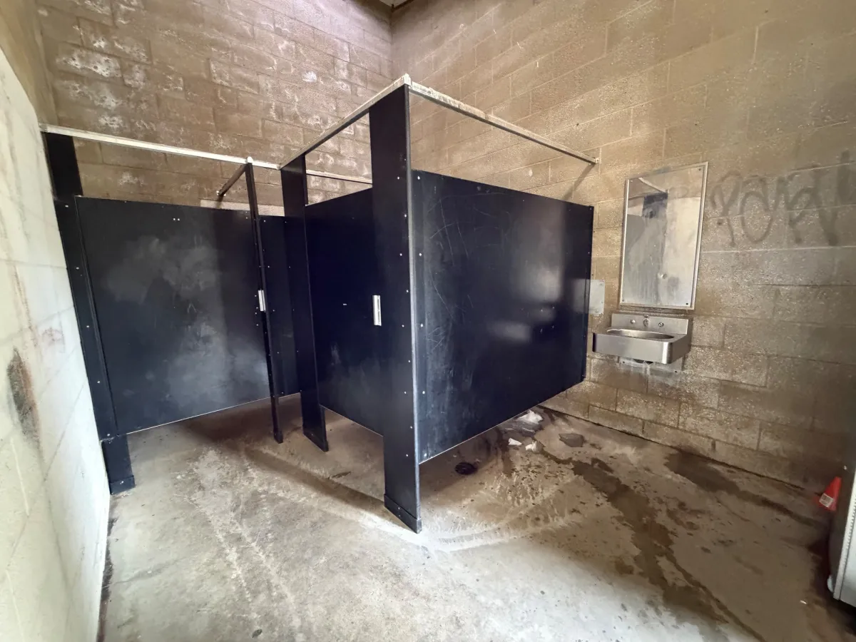Bathroom interior at back of grass fields