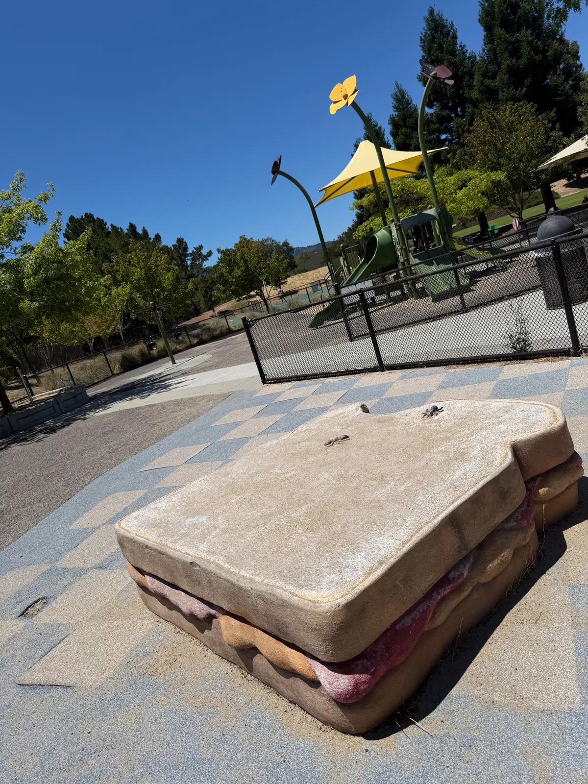 Picnic themed seating area complete with a partially eaten sandwich bench and fake ants