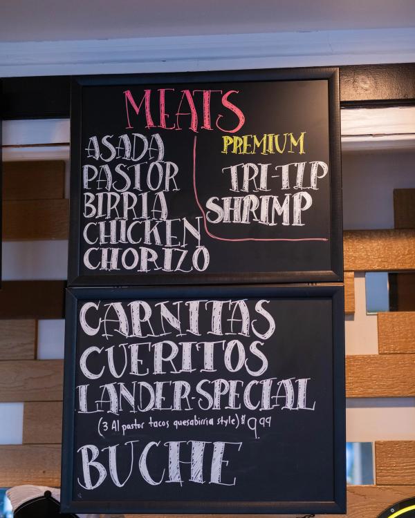 Handwritten chalkboard menu of meats and specials