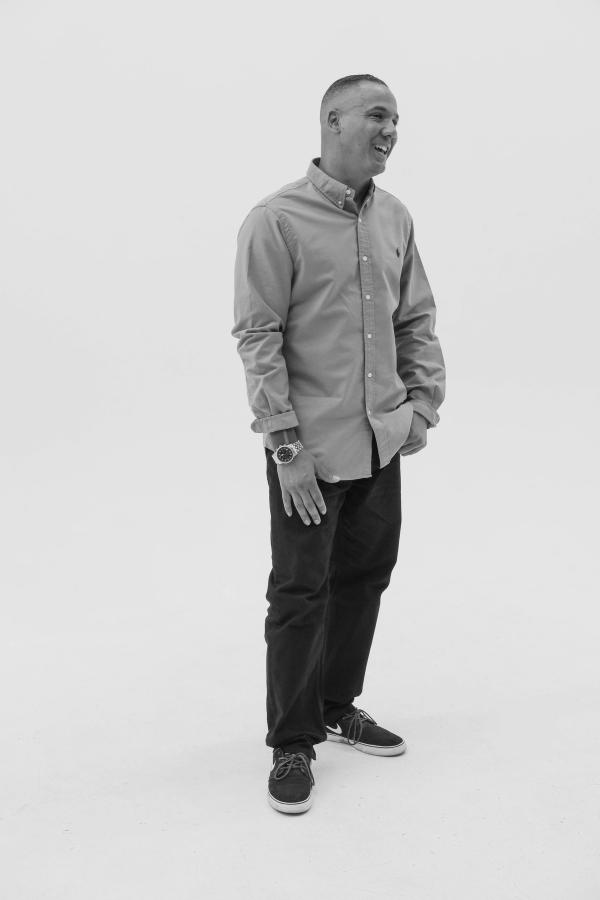 Full-length portrait of a man glancing back over his shoulder