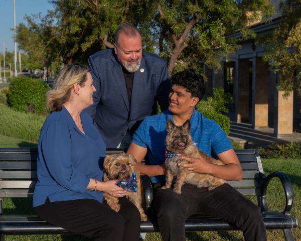 Candidate with his family and their dog on a park bench