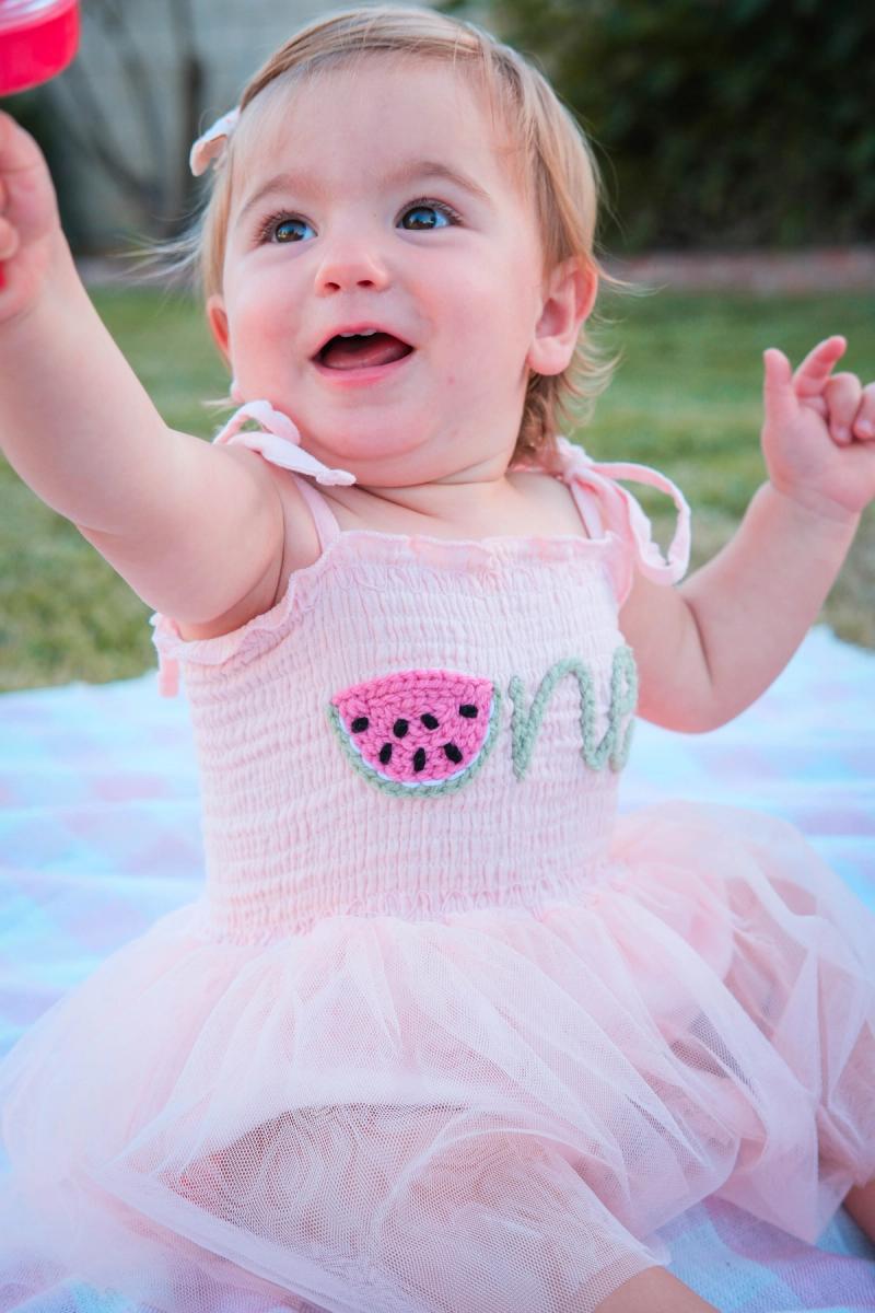 Delighted toddler reaching up with a big open-mouthed smile