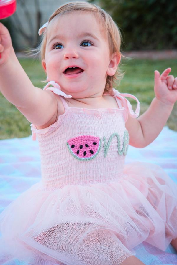Delighted toddler reaching up with a big open-mouthed smile