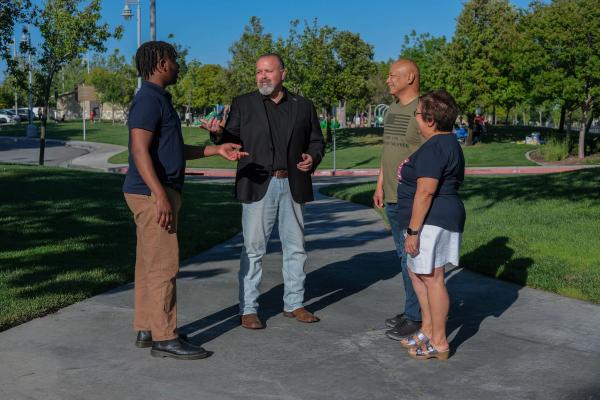 Candidate talking with community members in a park