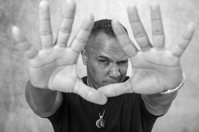 Man framing his face with both hands, palms to the camera