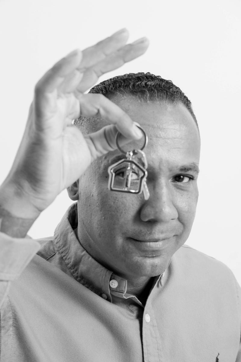 Playful close-up of a man framing his eye with his hand