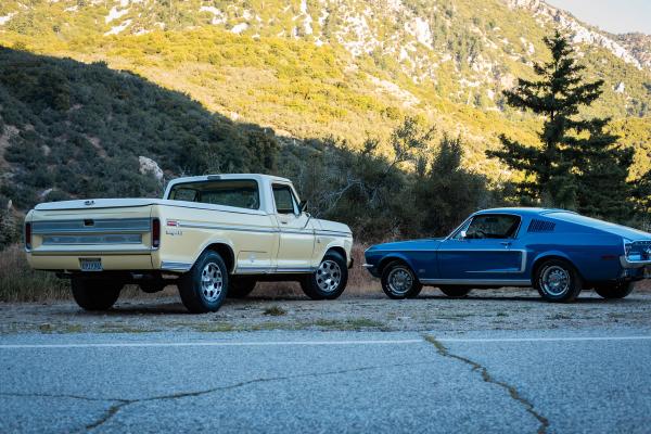 Pickup and Mustang parked side by side on a mountain road