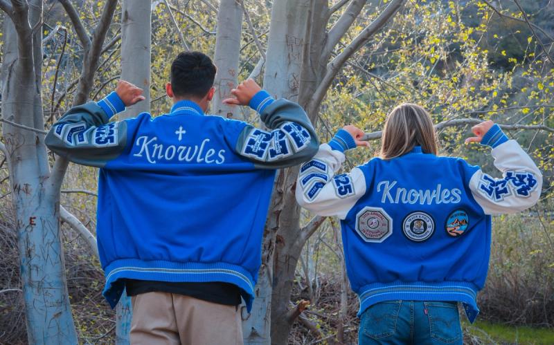 Two seniors showing the backs of their Knowles letterman jackets
