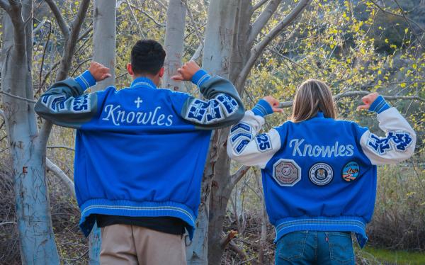 Two seniors showing the backs of their Knowles letterman jackets