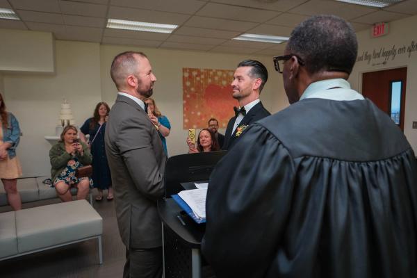 Officiant leading the ceremony as family and friends look on