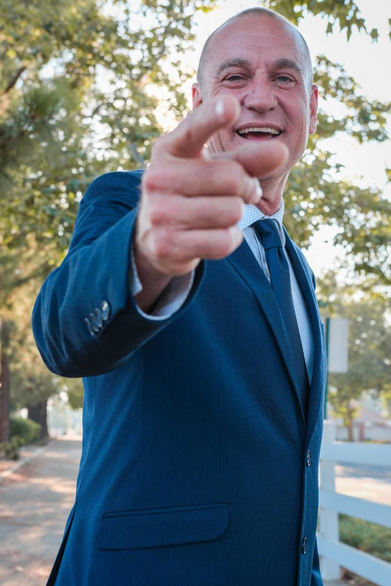 Candidate pointing at the camera with a big smile