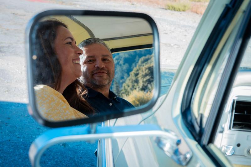 Couple laughing inside the Mustang through the open window
