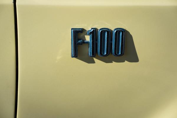 Detail of an F100 badge on a cream truck