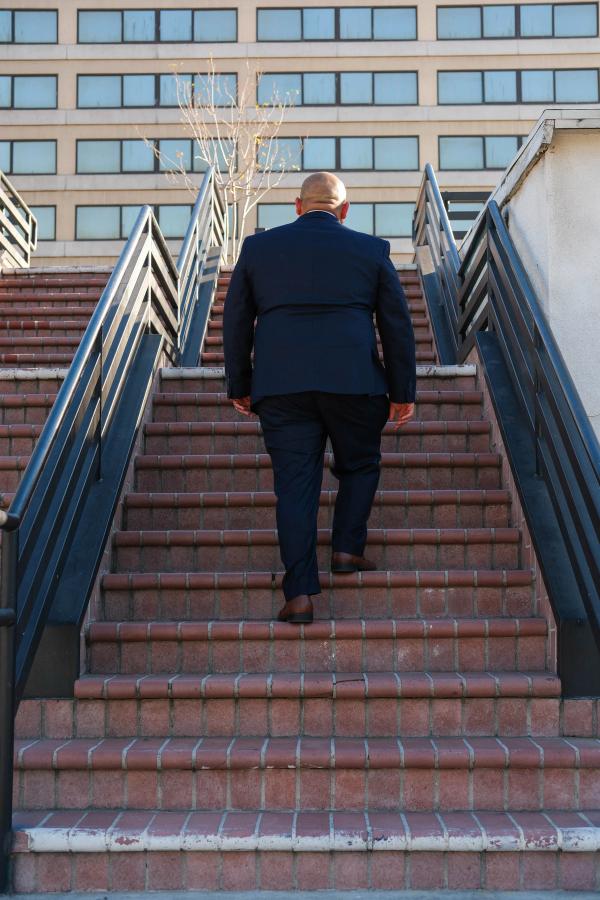Candidate walking up a long outdoor staircase downtown