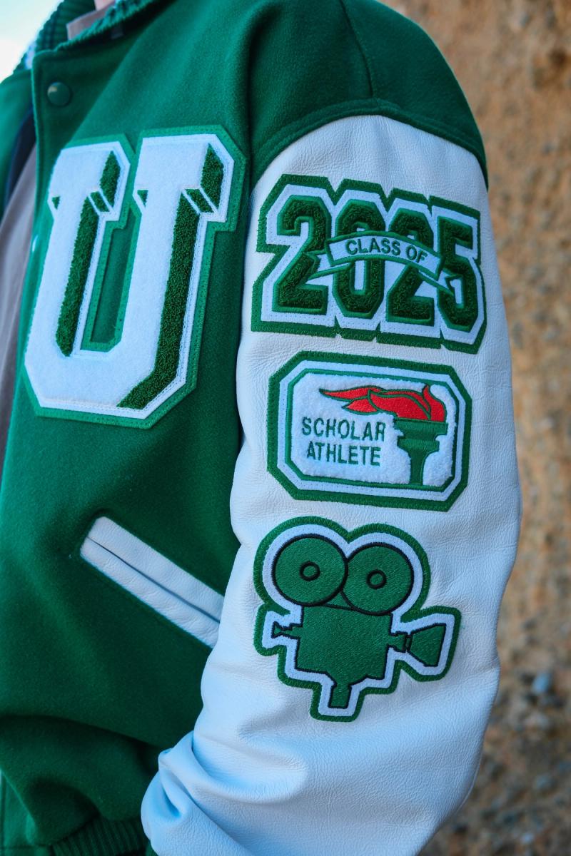 Detail of letterman jacket patches: Class of 2025, scholar athlete and film camera
