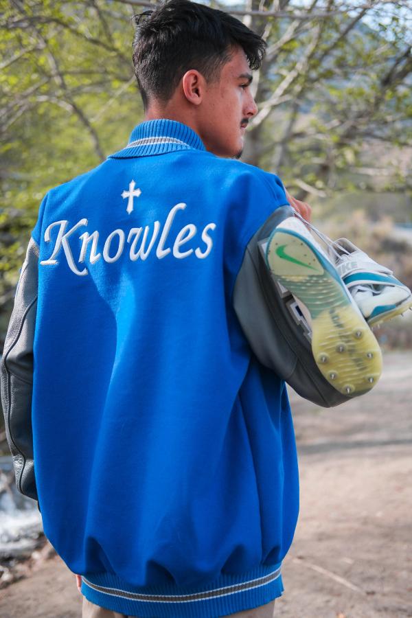 Senior looking over his shoulder, Knowles embroidered on his jacket