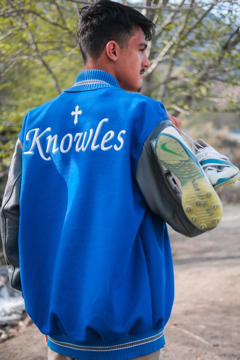 Senior looking over his shoulder, Knowles embroidered on his jacket