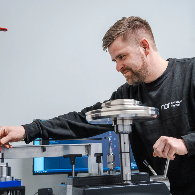 A man operates industrial testing equipment.