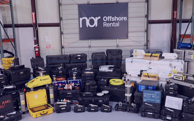 A wide array of black, yellow, and white offshore rental equipment displayed in a warehouse beneath a "nor Offshore Rental" banner.