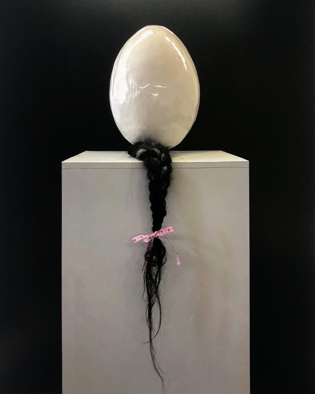 You Almost Broke Me, 2022. Clay, human hair, screams, stories, glaze, polyester ribbon. 30 × 25 cm