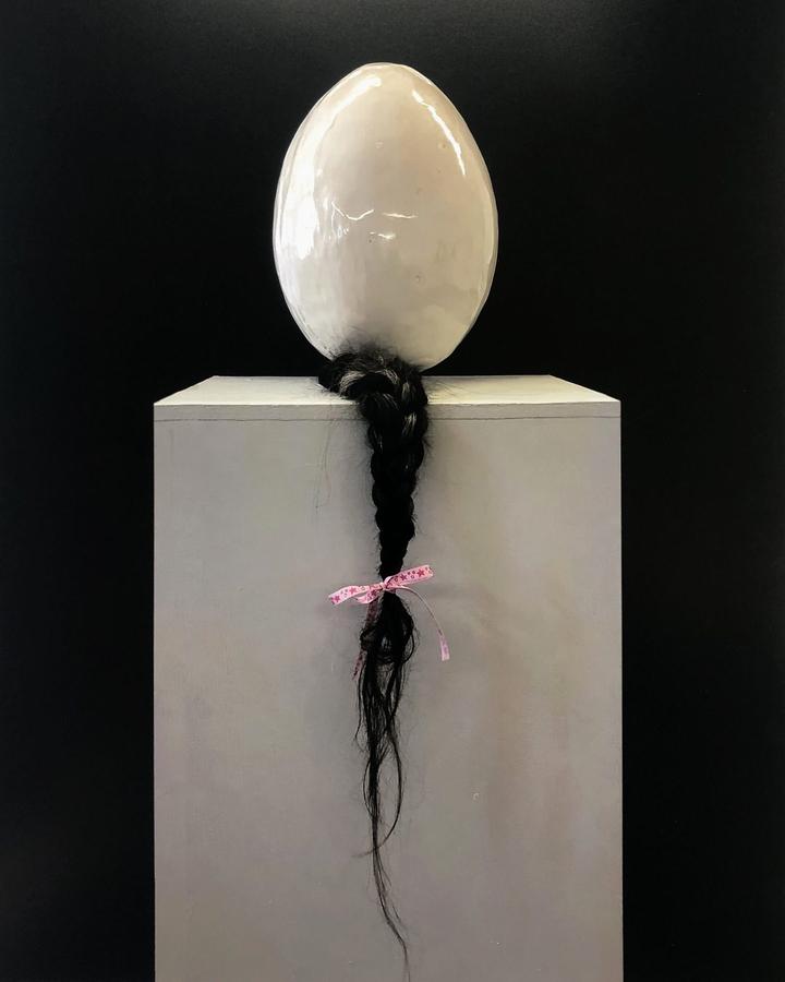 You Almost Broke Me, 2022. Clay, human hair, screams, stories, glaze, polyester ribbon. 30 × 25 cm
