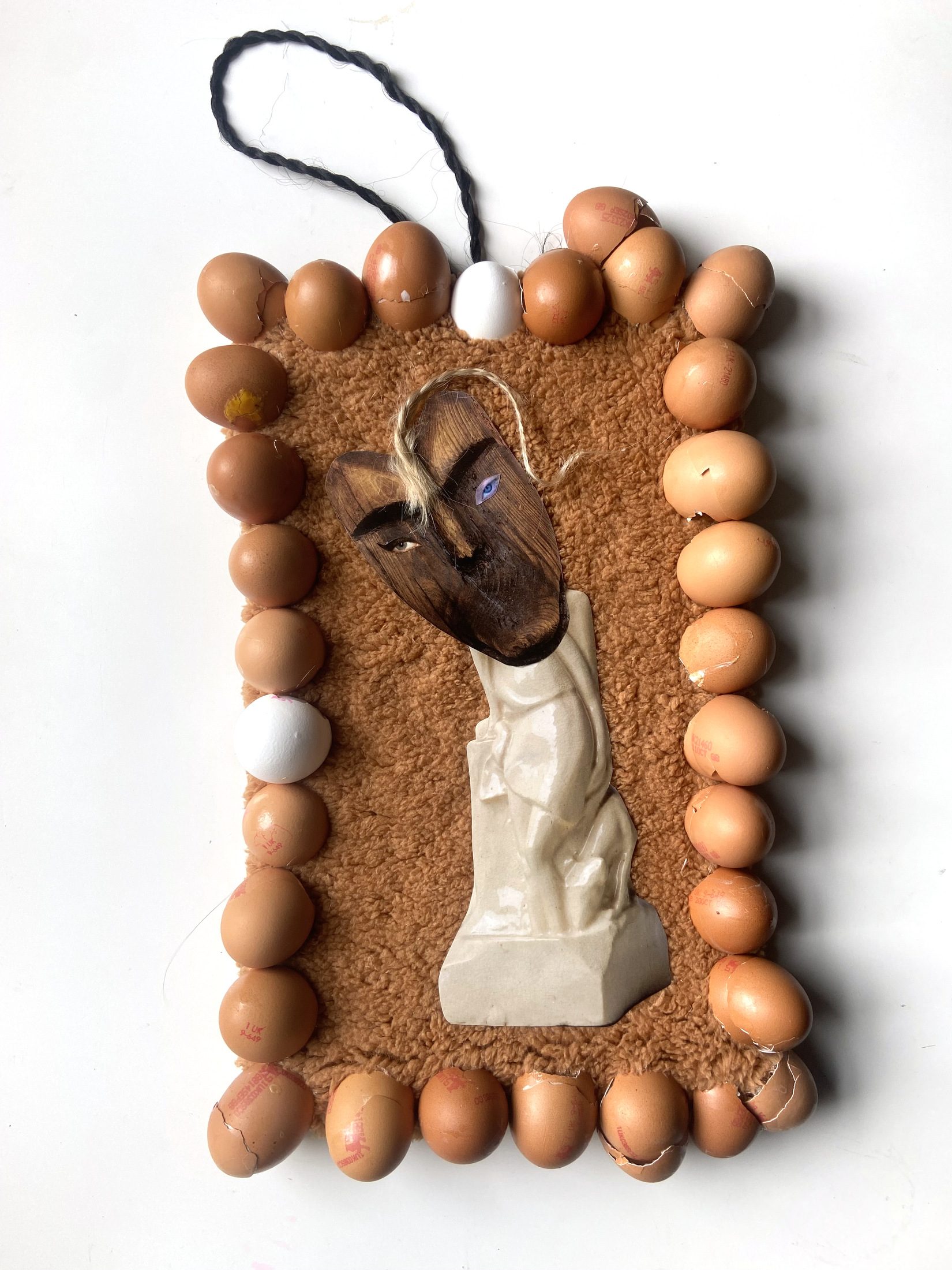 Eggshells, fleece, carved wood, ceramic, hair