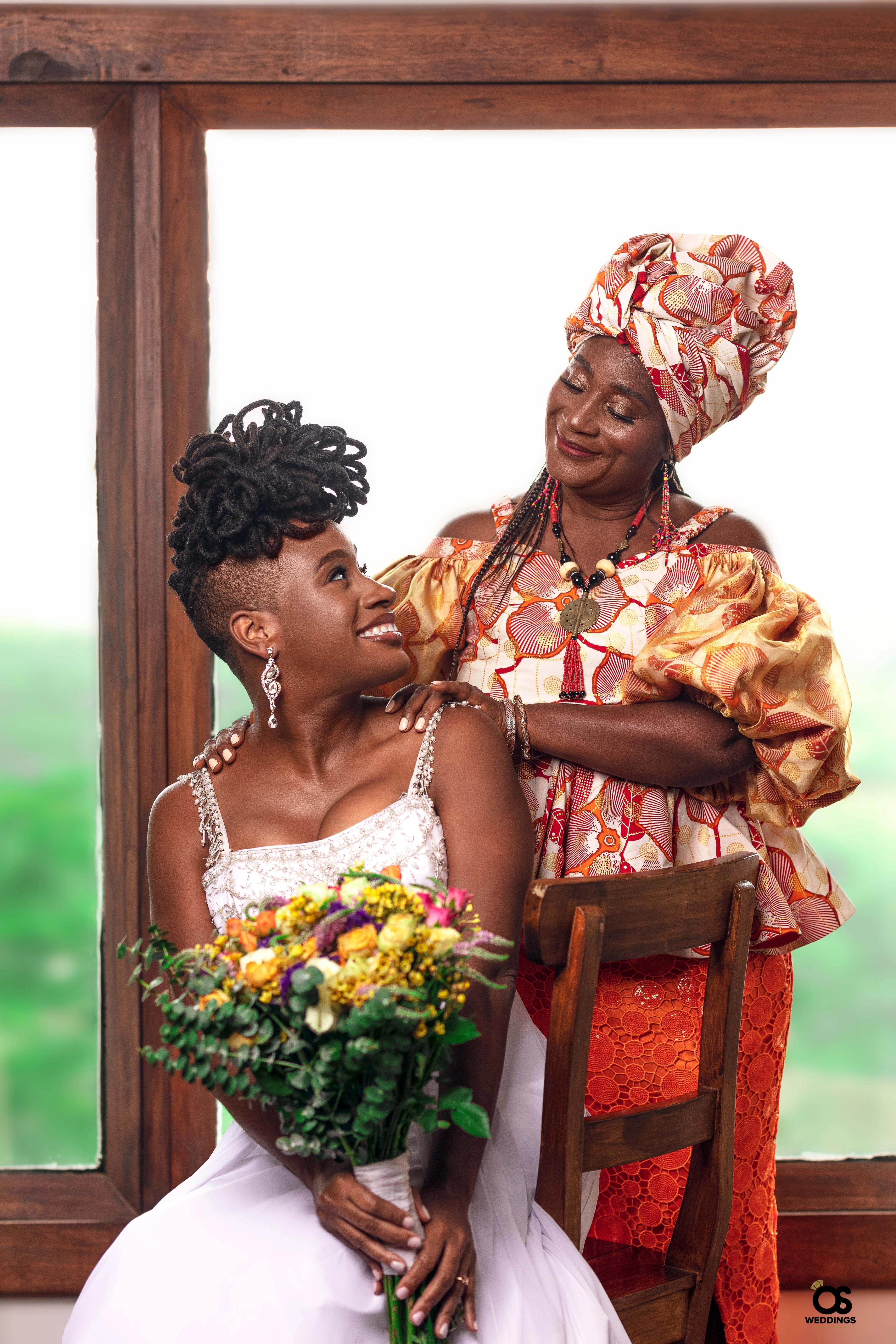 Traditional Ghanaian bride sharing a joyful moment with Mother during the wedding ceremony.