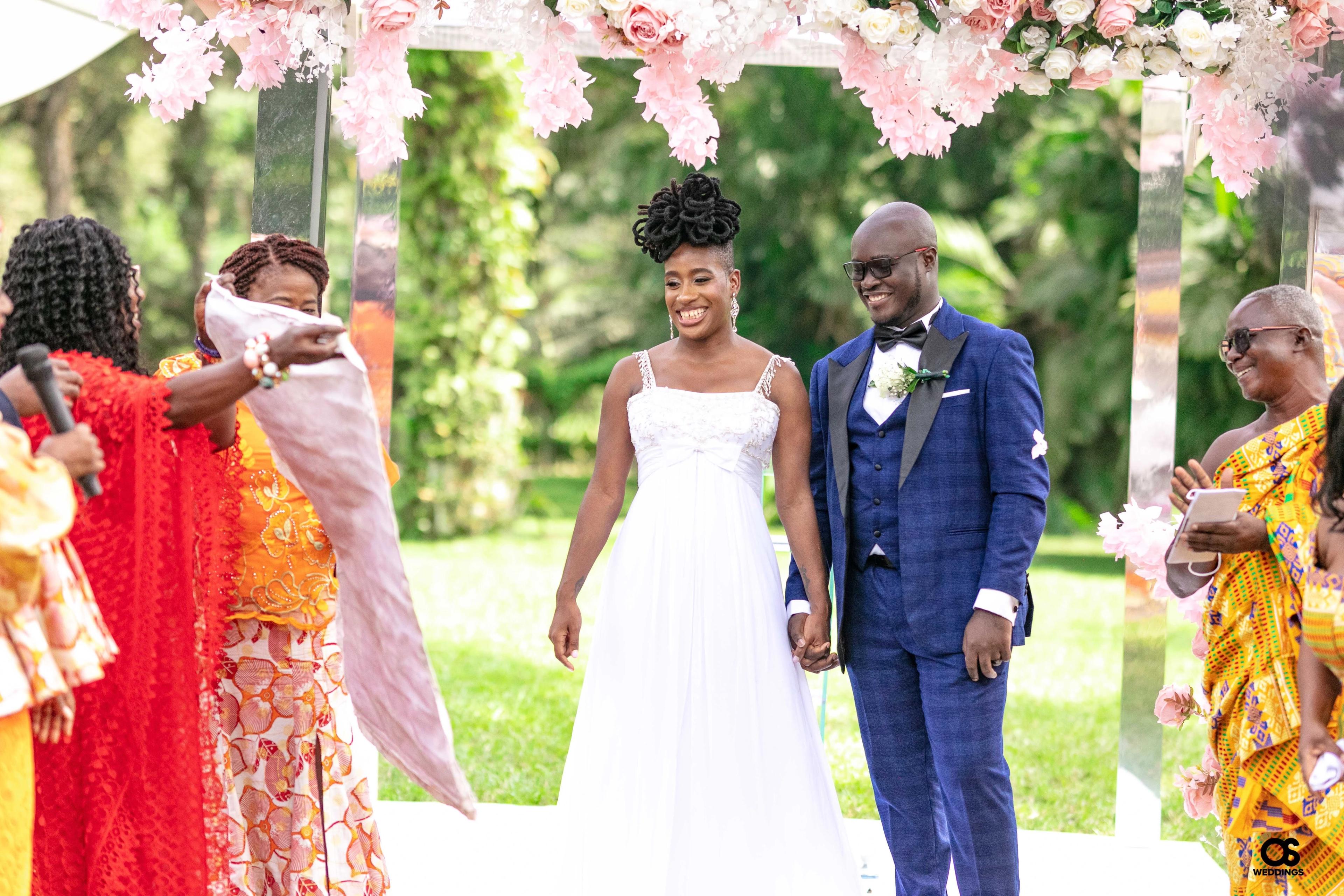 Bride and groom laughing together during portraits.