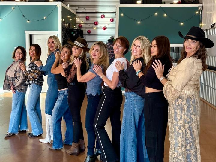 A line of lovely ladies poses after a line dance class.