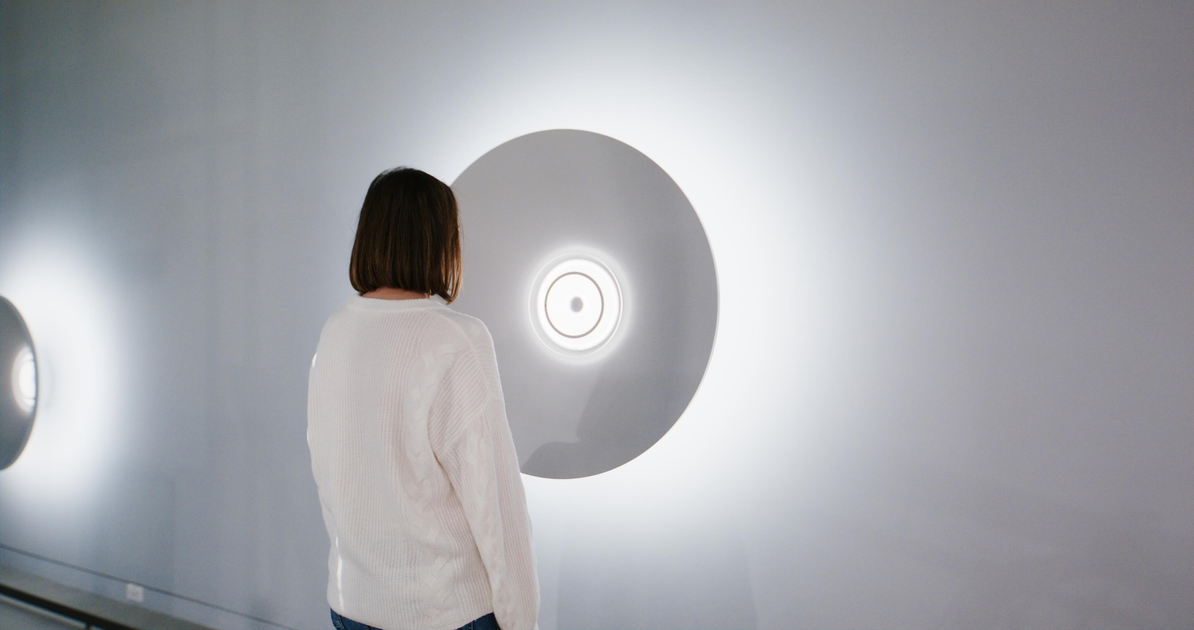 Custom audio cones at the MIT Museum feature recordings from researchers, triggered by visitors and highlighted with pulsing lights and LED rings.