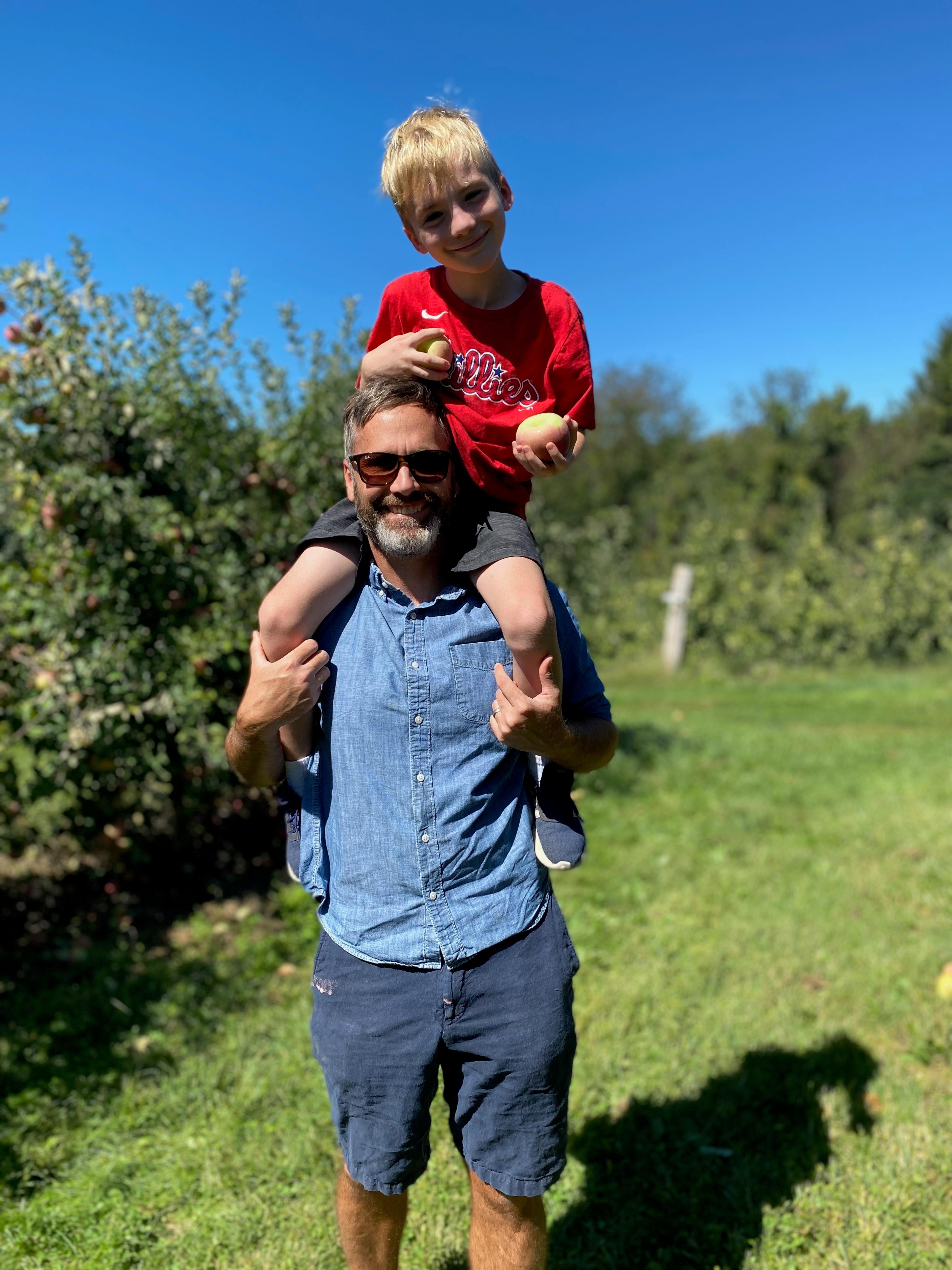 Troy with his son on his shoulders